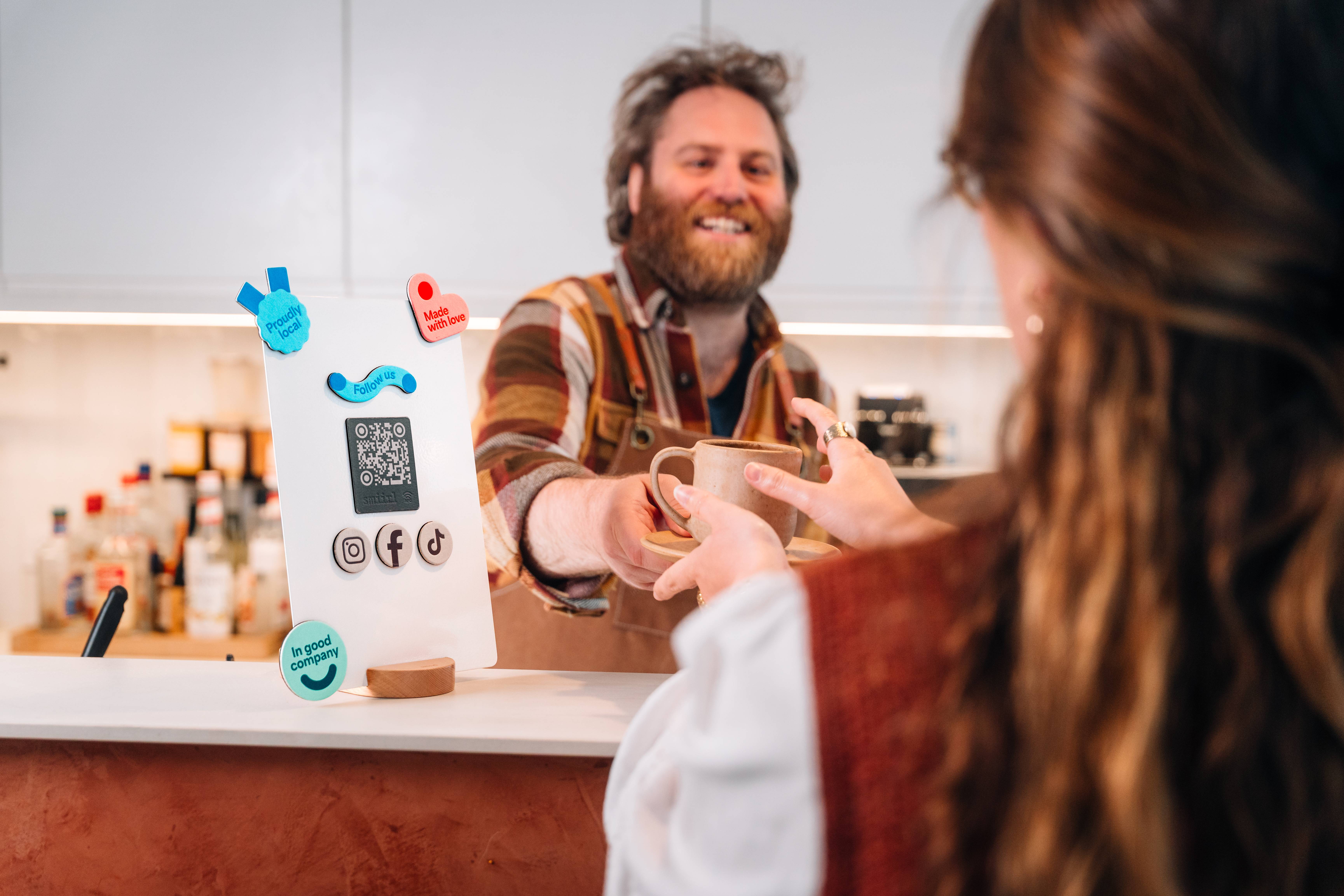 barista giving a cup of coffee